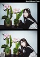 A woman sitting next to a potted plant with pink flowers.